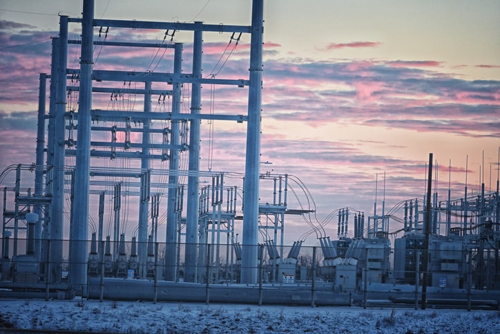 Electrical substation beneath a colorful sunset sky
